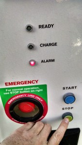 Press and hold the small green stop button